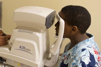 autorefractor ethnic boy exam